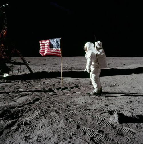 Buzz Aldrin standing on the Moon near the American flag during the Apollo 11 mission